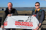 Geoffrey and Mr Ryan hold up a banner which reads: "WALKING WITH THE WOUNDED; Supporting Those Who Served."